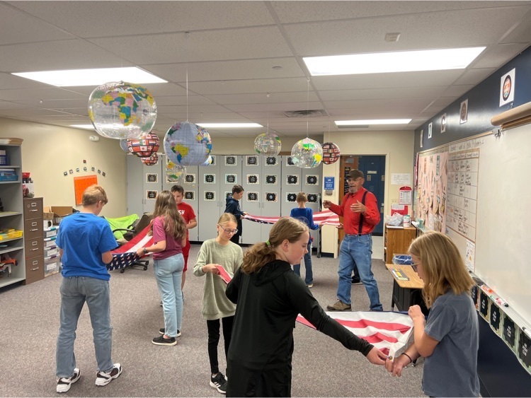 Lynn Swanson from VFW Legion Post 213  showing 6th grade how to properly fold our flag.