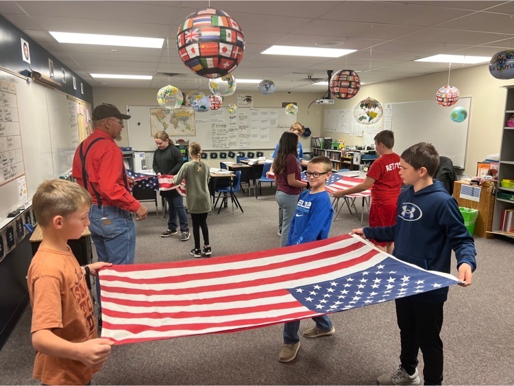 Lynn Swanson from VFW Legion Post 213 showing 6th grade how to properly fold our flag.
